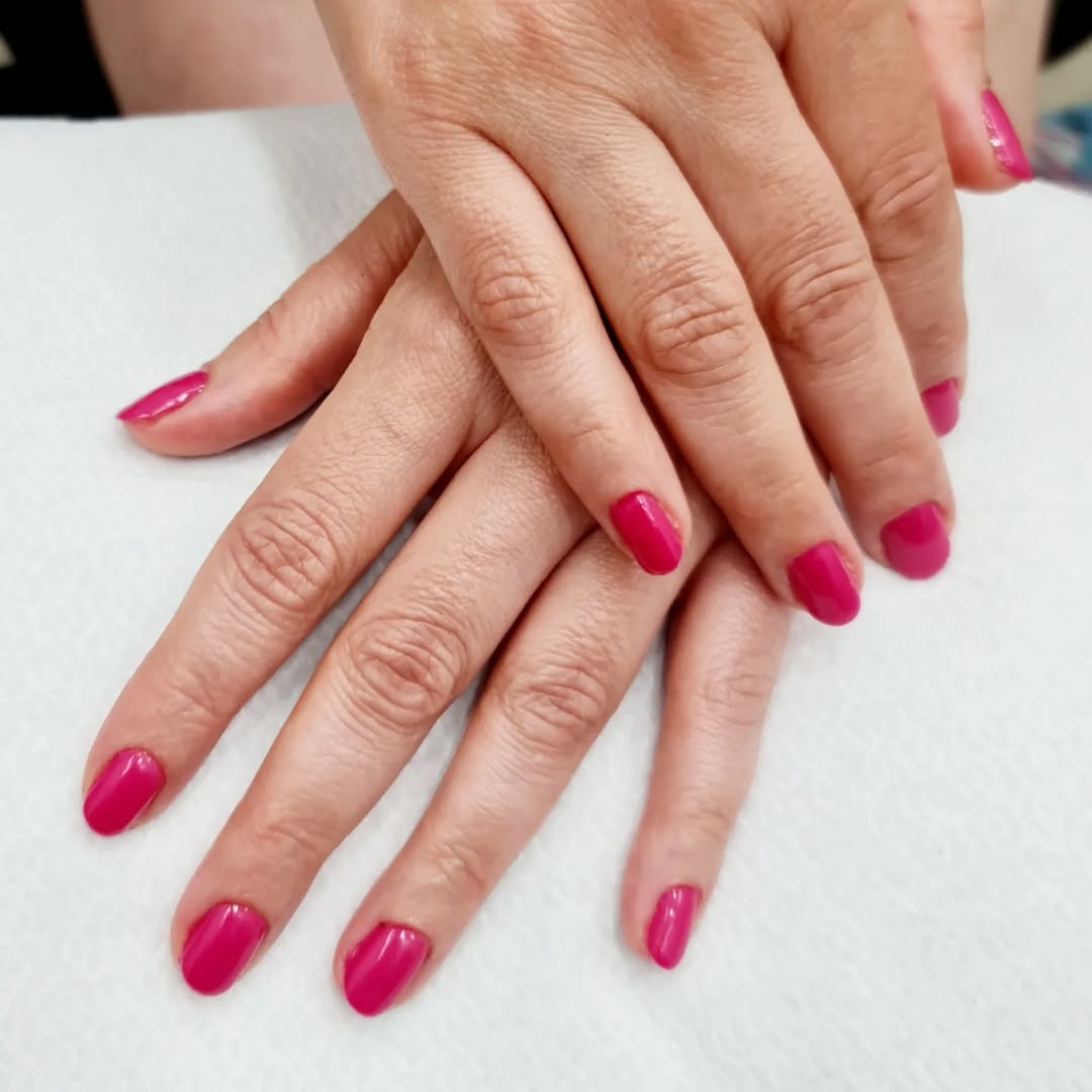 Manicura en color fucsia brillante, representando los servicios de estética en peluquería y estética en Puerto del Carmen Las Palmas.